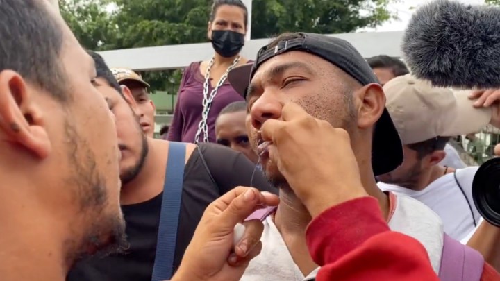 Personas migrantes de cosen los labios 