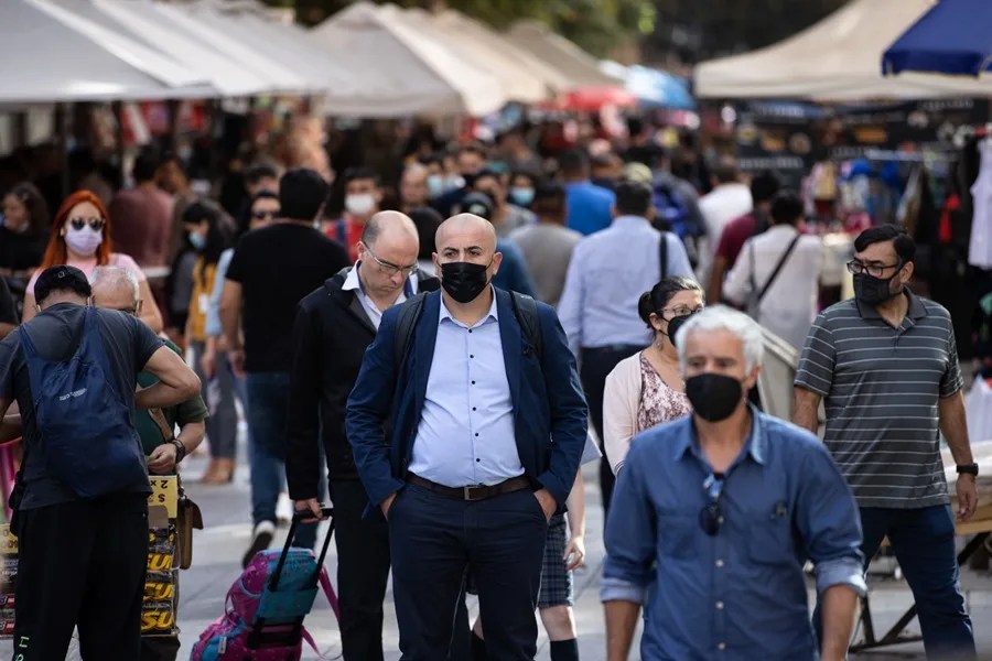 Personas caminan con mascarilla en Santiago de Chile. EFE/Alberto Valdés
